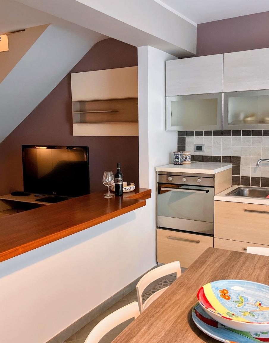 Kitchen with oven, breakfast bar and dining table